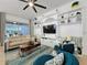 Comfortable living room with a built-in entertainment center and large windows overlooking the backyard at 135 Crepe Myrtle Dr, Groveland, FL 34736