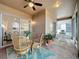 Covered patio with brick flooring, ceiling fan and wicker furniture set at 135 Crepe Myrtle Dr, Groveland, FL 34736