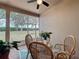 Enclosed lanai with view of backyard and wicker furniture set at 135 Crepe Myrtle Dr, Groveland, FL 34736