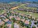 Expansive aerial view showcasing the golf course community and nearby lakes surrounding this neighborhood's serene location at 1408 Deuce Cir, Davenport, FL 33896