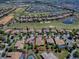 Aerial view of a ChampionsGate home highlighting the lush landscaping and golf course views at 1408 Deuce Cir, Davenport, FL 33896
