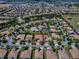 Aerial view of the neighborhood with lush landscaping, tree-lined streets, and meticulously maintained homes in a golf community at 1408 Deuce Cir, Davenport, FL 33896