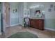 Bright bathroom featuring tile flooring, a decorative chair, and a dark wood vanity with granite countertops at 1408 Deuce Cir, Davenport, FL 33896