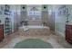 Bathroom featuring a tiled tub, dual entry shower, tile floor, and green accents at 1408 Deuce Cir, Davenport, FL 33896