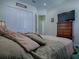Comfortable bedroom with a bed, dresser, television and a closet with white sliding doors at 1408 Deuce Cir, Davenport, FL 33896