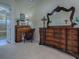 Bedroom featuring an antique desk, decorative dresser with large mirror, and neutral carpet at 1408 Deuce Cir, Davenport, FL 33896