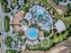 Aerial view of the ChampionsGate community pool featuring lazy river, multiple pools, and a splash area at 1408 Deuce Cir, Davenport, FL 33896