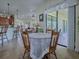 Bright dining area featuring a round table, wooden chairs, and access to the outdoor patio at 1408 Deuce Cir, Davenport, FL 33896