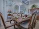 Elegant dining room displaying a formal dining table with seating, lit by modern chandeliers, with an open view at 1408 Deuce Cir, Davenport, FL 33896