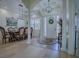Inviting foyer leads to an elegant dining area, showcasing stylish chandeliers and natural light streaming through the windows at 1408 Deuce Cir, Davenport, FL 33896