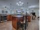 Open-concept kitchen featuring a center island, pendant lighting, and seamlessly connected to the living area at 1408 Deuce Cir, Davenport, FL 33896