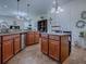 Kitchen featuring an island, stainless appliances, ample cabinetry, and open floor plan to other living spaces at 1408 Deuce Cir, Davenport, FL 33896