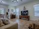 Comfortable living room featuring tile flooring and a bright window overlooking a backyard dining space at 1408 Deuce Cir, Davenport, FL 33896
