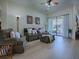 Comfortable living room with hardwood floors, plush seating, and sliding doors to an outdoor patio at 1408 Deuce Cir, Davenport, FL 33896