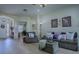Inviting living room featuring wood floors and neutral decor with comfortable seating arrangement at 1408 Deuce Cir, Davenport, FL 33896
