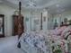 Beautiful main bedroom with a decorative four-poster bed, tray ceiling, and plenty of closet space at 1408 Deuce Cir, Davenport, FL 33896