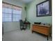 Functional home office space with a window for natural light and practical furnishings at 1408 Deuce Cir, Davenport, FL 33896