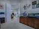 This home office has an open doorway with a view to the living room, offering a cohesive living and work experience at 1408 Deuce Cir, Davenport, FL 33896