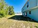 Spacious backyard with partial grass cover and a white fence surrounding the property at 1420 Kissimmee Ct, Kissimmee, FL 34759