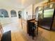 Open kitchen with granite island, stainless refrigerator and arched doorway at 1420 Kissimmee Ct, Kissimmee, FL 34759