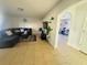 Living room with tile flooring, stylish furniture, and an arched doorway to office at 1420 Kissimmee Ct, Kissimmee, FL 34759