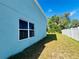 Side yard with a well-maintained lawn and a privacy fence at 1420 Kissimmee Ct, Kissimmee, FL 34759