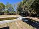 Backyard view with an in-ground pool and mature trees surrounding the perimeter at 14346 Sw 39Th Ter, Ocala, FL 34473