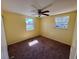 Bedroom highlighting yellow walls, carpeted floor, and natural light from two windows at 14346 Sw 39Th Ter, Ocala, FL 34473
