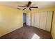 Bedroom featuring a ceiling fan, carpet, and a closet with multiple doors at 14346 Sw 39Th Ter, Ocala, FL 34473