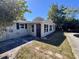 Exterior view of the home with a screen door entrance and a partial view of an in-ground pool at 14346 Sw 39Th Ter, Ocala, FL 34473