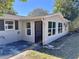 Exterior view of the home with a screen door entrance and multiple windows for plenty of light at 14346 Sw 39Th Ter, Ocala, FL 34473