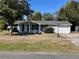 Charming single-story home featuring a covered entrance, attached garage, and a well-maintained lawn at 14346 Sw 39Th Ter, Ocala, FL 34473