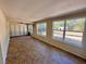 Sun room with tile flooring, lots of windows, ceiling fan, and access to the pool area at 14346 Sw 39Th Ter, Ocala, FL 34473