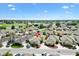 An aerial view of a beautiful single-Gathering home in a lush community with water views, mature landscaping, and serene surroundings at 1536 Barnwell Pl, The Villages, FL 32162