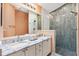Beautiful bathroom featuring double sinks, a large mirror, and a modern walk-in shower at 1536 Barnwell Pl, The Villages, FL 32162