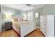 Cozy bedroom with laminate flooring, a ceiling fan, and a decorative accent mirror at 1536 Barnwell Pl, The Villages, FL 32162