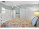Comfortable bedroom featuring laminate flooring, closet space, and neutral decor at 1536 Barnwell Pl, The Villages, FL 32162
