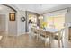 Cozy dining room featuring tile flooring, a modern chandelier, and a charming view into the kitchen at 1536 Barnwell Pl, The Villages, FL 32162