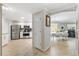 Open concept kitchen with stainless steel appliances, white cabinets, and views into the dining and living area at 1536 Barnwell Pl, The Villages, FL 32162