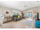 Spacious living area with tile flooring, a ceiling fan, and a comfortable gray sofa at 1536 Barnwell Pl, The Villages, FL 32162