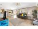 Open-concept living space seamlessly blends living and dining areas with tile floors and neutral tones at 1536 Barnwell Pl, The Villages, FL 32162