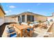 Charming patio area with comfortable seating, dining space, and a vibrant mural creating a relaxing outdoor setting at 1536 Barnwell Pl, The Villages, FL 32162