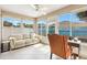 Inviting sunroom featuring tile flooring, large windows offering plenty of natural light, and comfortable seating at 1536 Barnwell Pl, The Villages, FL 32162