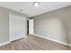 Bedroom featuring new paint and wood-look floors as well as double closets and a six panel door at 1566 Lawndale Cir, Winter Park, FL 32792