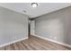 Neutral-walled bedroom with new wood-look flooring, a closet and a six panel door at 1566 Lawndale Cir, Winter Park, FL 32792