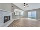 Comfortable living room with brick fireplace, ceiling fan, and sliding door at 1566 Lawndale Cir, Winter Park, FL 32792