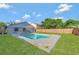 Inviting backyard pool with a well-maintained lawn and privacy fence, perfect for outdoor relaxation and entertaining at 1566 Lawndale Cir, Winter Park, FL 32792