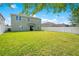 Expansive backyard with lush green grass, a white fence, and ample space for outdoor activities at 161 Williamson Dr, Davenport, FL 33897