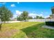 Large grassy backyard enclosed by a white fence, perfect for outdoor entertaining and play at 161 Williamson Dr, Davenport, FL 33897