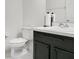 Well-maintained half bathroom with a dark wood vanity, white sink, and modern fixtures at 161 Williamson Dr, Davenport, FL 33897